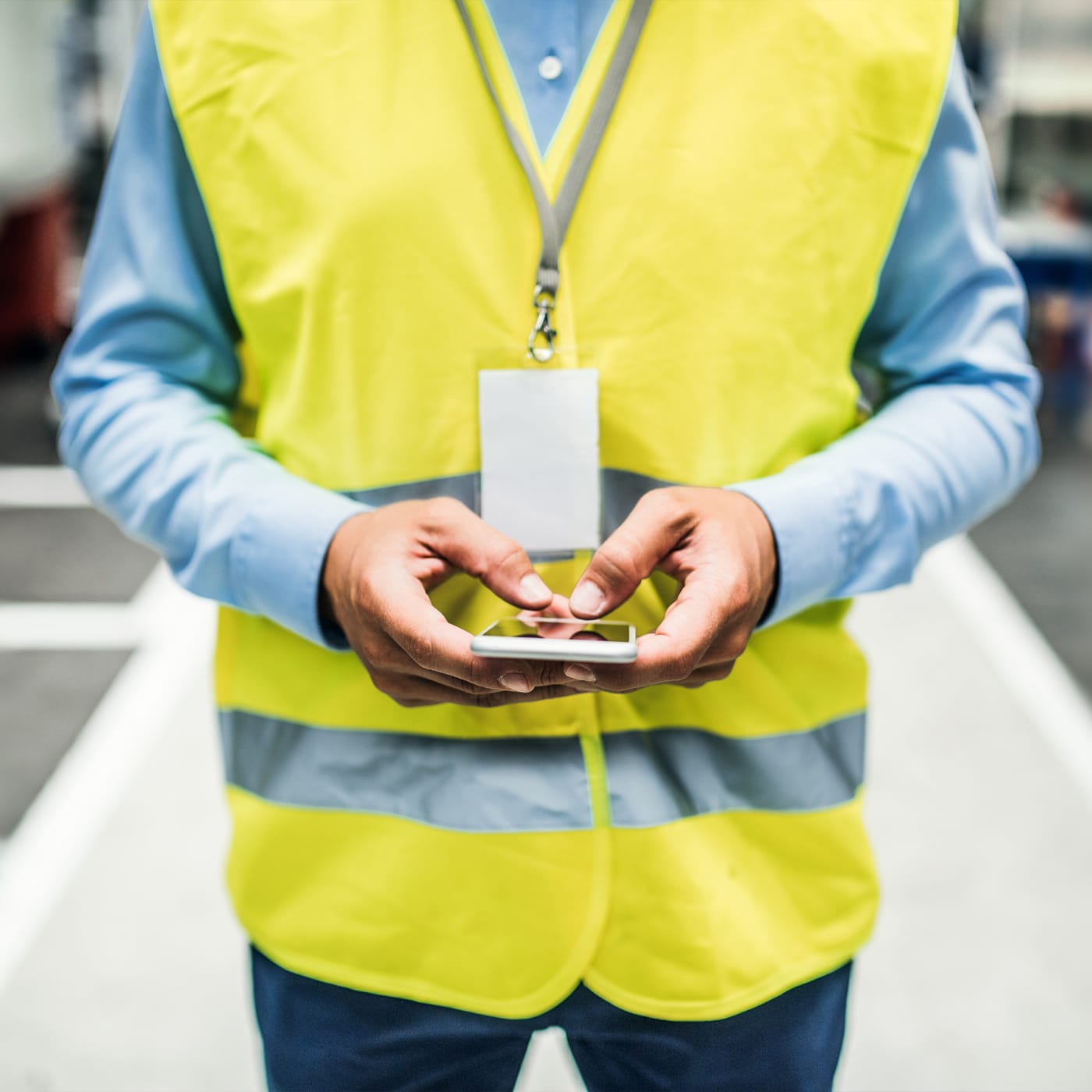 Engineer using smartphone in factory